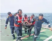  ?? ?? Coast Guard jawans bring one of the crew members to shore