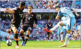  ??  ?? Hull City’s Ahmed Elmohamady (left) blocks a shot by Manchester City’s Nolito (right) during their English Premier League match at the Etihad Stadium on Saturday. –