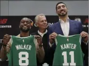  ?? ELISE AMENDOLA - THE ASSOCIATED PRESS ?? Newly acquired Boston Celtics guard Kemba Walker (8) and center Enes Kanter (11) pose with their team jerseys at the Celtics’ basketball practice facility, Wednesday, July 17, 2019, in Boston. Looking on is team general manager Danny Ainge.