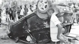  ??  ?? A man who is believed to have been driving while chatting on his mobile phone had his car mount a pavement before landing on its roof at Centenary Park in Bulawayo yesterday. —Picture by Stanley Moyo