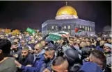  ?? (AFP) ?? Palestinia­n mourners carry the body of Walid al-Sharif at Jerusalem’s flashpoint Al-Aqsa mosque compound, on Tuesday