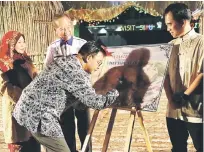  ??  ?? Abdul Karim signs a board to launch the book while (from left) Rogayah,Tiong and Hii look on.