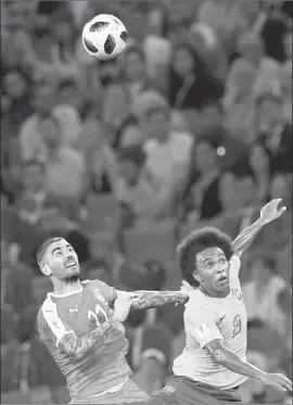  ?? Francisco Leong AFP/Getty Images ?? SERBIA’S Aleksandar Kolarov, left, battles Brazil forward Willian for the ball during their Group E match at Moscow. Brazil got a goal in each half in the win.