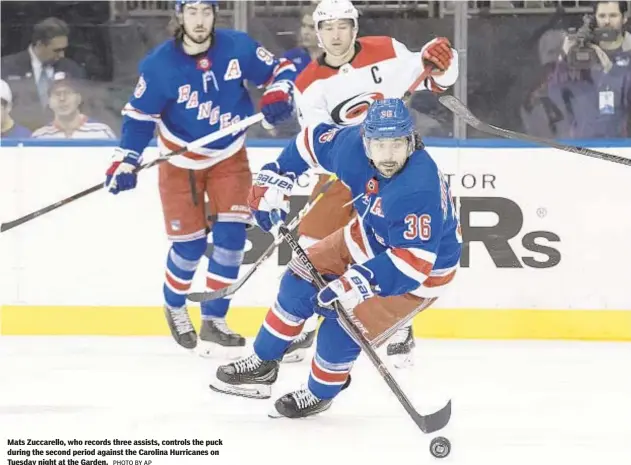  ?? PHOTO BY AP ?? Mats Zuccarello, who records three assists, controls the puck during the second period against the Carolina Hurricanes on Tuesday night at the Garden.