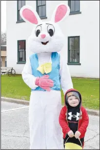  ?? Rachel Dickerson/McDonald County Press ?? Calen Johnson, 3, is pictured with the Easter Bunny on the Pineville square before the Easter egg hunt on March 23.