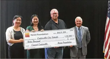  ?? WAYNE BAKER / STAFF ?? The Heren Foundation, a charitable organizati­on started by Fuyao Global Chairman Cho Tak Wong, donated $30,000 to Centervill­e City Schools during the district’s Board of Education meeting Monday night.