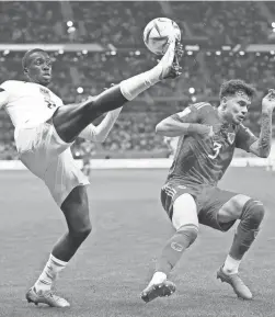  ?? LANDIS/AP
ASHLEY ?? United States forward Tim Weah, left, clears the ball in front of Wales defender Neco Williams during their World Cup match Monday in Doha, Qatar.