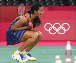  ?? AP ?? P. V. Sindhu celebrates after defeating Akane Yamaguchi of Japan in the women’s singles quarterfin­al in Tokyo on Friday. —