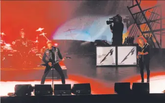  ?? Carlos Avila Gonzalez / The Chronicle ?? Metallica — including Lars Ulrich (left), James Hetfield and Kirk Hammett — rocks the stage at the Band Together Bay Area benefit concert at AT&amp;T Park for victims of the North Bay fires.