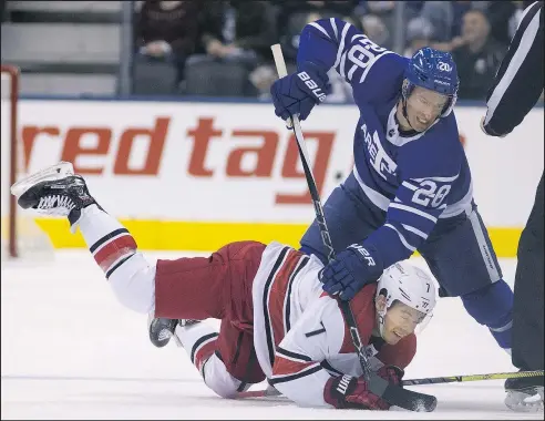  ?? STAN BEHAL/TORONTO SUN FILES ?? Ex-Leaf Dominic Moore battles for the puck with Carolina’s Derek Ryan last season.