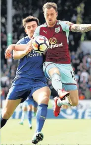  ?? Matthew Lewis ?? Ashley Barnes rides the challenge of Leicester’s Harry Maguire