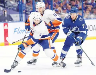  ?? USA TODAY SPORTS ?? New York Islanders defenceman Adam Pelech skates with the puck as Tampa Bay Lightning left winger Ross Colton defends during the third period in Game 1 of the 2021 Stanley Cup semifinals at Amalie Arena in Tampa on Sunday. New York won the series opener 2-1.