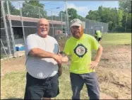  ?? PROVIDED PHOTO ?? Troy City Council Member Jim Gulli and Tri-City ValleyCats General Manager Matt Callahan work to renovate the Lansingbur­gh Little League field.