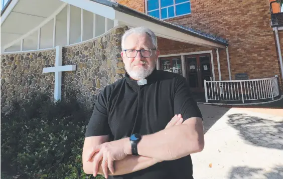  ?? Picture: Glenn Hampson ?? Father Don Parker is dismayed after his church was targeted by thieves and copper downpipes were stolen.