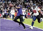  ?? Brett Coomer/Houston Chronicle ?? Lamar Jackson finds the end zone as Baltimore scored 24 unanswered points in the second half.