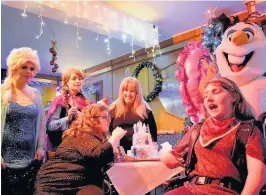  ??  ?? Birthday cake Helen (seated left) checks out her cake with friend Clare Morrow (front right), mum Jean and Frozen characters Elsa, Anna and Olaf