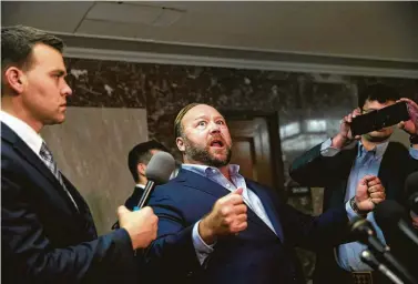  ?? Eric Thayer / New York Times ?? Alex Jones, center, the right-wing conspiracy theorist and talk show host, sparred with Sen. Marco Rubio, R-Fla., on Capitol Hill on Wednesday. “You are literally like a little gangster thug,” Jones said to Rubio.