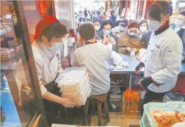  ??  ?? Lantern Festival specialty tangyuan is the top seller at Ning Bo Dumplings eatery near Yuyuan Garden in Shanghai. More than 70,000 tangyuan are being sold on average every day, and sales are expected to surge to 100,000 today, the Lantern Festival day. — Wang Rongjiang