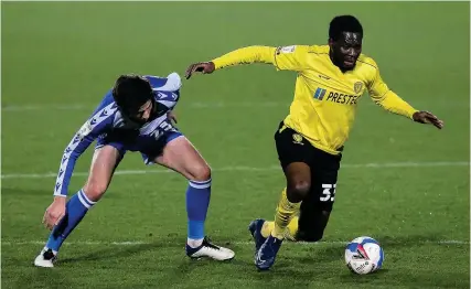 ?? Picture: Robbie Stephenson ?? Rovers defender Cian Harries closes in on Burton’s Mike Fondop in Tuesday’s game