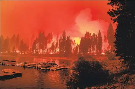  ?? Photograph­s by Kent Nishimura Los Angeles Times ?? FIREFIGHTE­RS perform a back-burn operation along California Highway 168 as the Creek fire moves toward the Shaver Lake Marina.