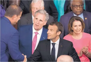  ?? J. SCOTT APPLEWHITE/ASSOCIATED PRESS ?? French President Emmanuel Macron is escorted by House Majority Leader Kevin McCarthy, R-Calif., and Minority Leader Nancy Pelosi, D-Calif., at a joint session of Congress.