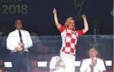  ?? Reuters ?? President of Croatia Kolinda Grabar-Kitarovic celebrates after Croatia’s first goal as President of France Emmanuel Macron and President of Russia Vladimir Putin look on.