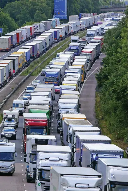  ??  ?? Gridlock: Lorries backed up on both carriagewa­ys of the M20 as part of Operation Stack yesterday