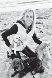  ?? COURTESY PHOTO ?? Dr. Patricia Lufsy with her three dogs at the beach. She made an unexpected medical rescue at South Mission Beach on Feb. 9.