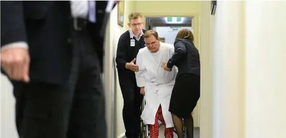  ?? PHOTO: DAVID NIELSEN ?? STEPPING DOWN: Ipswich Mayor Paul Pisasale is helped from his wheelchair at St Andrew’s Private Hospital, Ipswich, before announcing his resignatio­n.