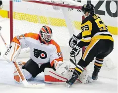  ?? — THE ASSOCIATED PRESS ?? Pittsburgh Penguins winger Jake Guentzel scores his second goal past Philadelph­ia Flyers goalie Brian Elliott on Monday in Pittsburgh.