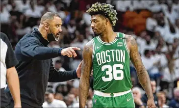  ?? LYNNE SLADKY/ASSOCIATED PRESS ?? Boston Celtics coach Ime Udoka, talking to guard Marcus Smart in Sunday’s Game 7 of the East finals against Miami, said testing his team’s mental toughness has been key, although there have been critics.