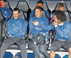  ??  ?? EN EL BANQUILLO. James bromeando con Bale y Marcelo.