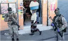  ?? Reuters ?? SOLDIERS patrol the streets during the lockdown. Judge Norman Davis found some lockdown regulation­s were ‘irrational’ and ‘invalid’.
|