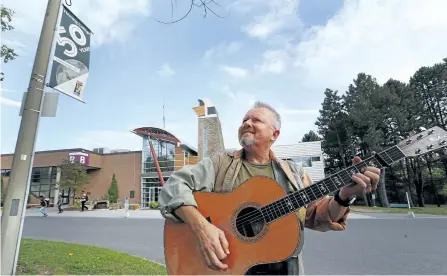  ?? CLIFFORD SKARSTEDT/EXAMINER ?? Local musician Danny Bronson plays a few notes on his guitar on Tuesday at Fleming College's Sutherland Campus. Bronson remastered the song he wrote for Fleming College 25 years ago to mark the college's 50th anniversar­y this year.