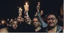  ?? STEPHANIE KEITH GETTY IMAGES ?? Mourners in Amsterdam, N.Y., attend a candleligh­t vigil Monday for the victims of the limousine crash that killed 20 people on Saturday.