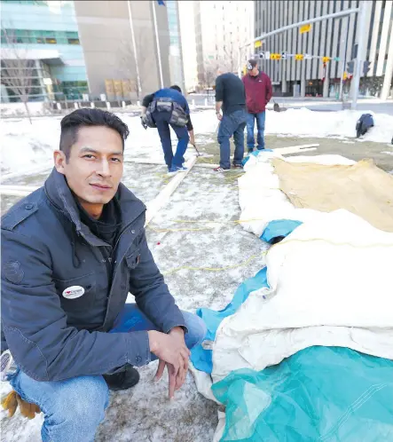  ?? JIM WELLS ?? Garret Smith, camp creator, and friends work to rebuild a camp downtown on Sunday across the street from the Calgary Courts Centre. The “Soaring Eagle’s Camp” will be re-raised and renamed Mohkinstsi­s to encompass the spirit and intent of the camp.
