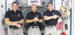  ?? AP ?? Astronaut Chris Cassidy (right) rings the opening bell at the Internatio­nal Space Station accompanie­d by Bob Behnken (left) and Doug Hurley.