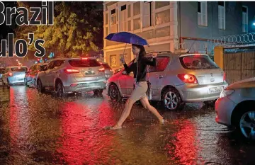  ??  ?? A woman crosses Mena Barreto street in Botafogo neighbourh­ood in Rio de Janeiro, Brazil. Uber also offers tailored service in Brazil for customers with old smartphone­s and slow internet connection­s as well as those who prefer to share their trip to save money. — AFP photo