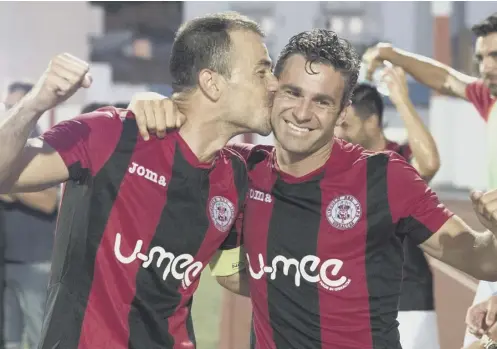  ??  ?? 0 Roy Chipolina plants a kiss on Lee Casciaro after the veteran’s goal back in 2016 gave Lincoln Red Imps a famous 1-0 victory over Celtic.