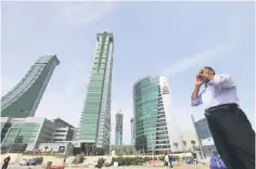  ??  ?? A person is seen standing at the junction of Bahrain Financial Harbour in Manama. — Reuters photo