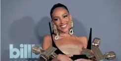  ?? | Reuters ?? DOJA Cat poses with her four awards at the Billboard Music Awards.