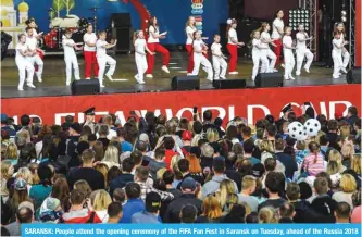  ?? AFP ?? SARANSK: People attend the opening ceremony of the FIFA Fan Fest in Saransk on Tuesday, ahead of the Russia 2018 World Cup.—