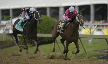  ??  ?? Flavien Prat atop Rombauer, right, breaks away from Irad Ortiz Jr atop Midnight Bourbon moments before crossing the finish line to win the Preakness Stakes horse race at Pimlico Race Course on Saturday in Baltimore. Photograph: Julio Cortez/AP