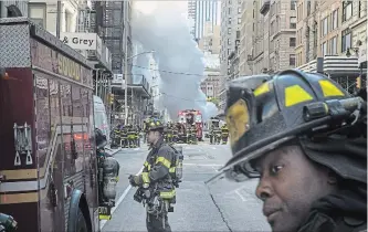  ?? DREW ANGERER GETTY IMAGES ?? Firefighte­rs work near the scene of a steam pipe explosion on Fifth Avenue in New York City.