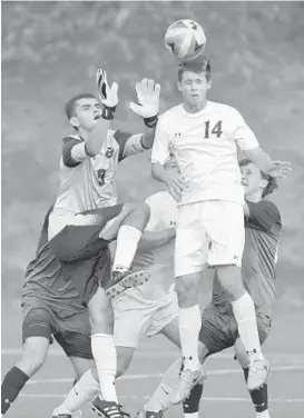  ?? LLOYD FOX/BALTIMORE SUN ?? Gilman goalkeeper John Philippou rises to make a save as Mount Saint Joseph’s Brett St. Martin (14) goes up for the header. Philippou made eight saves against the Gaels.