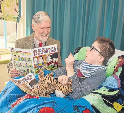  ??  ?? Robin Bell reads a copy of the comic to 13-year-old Brooklyn at Rachel House.