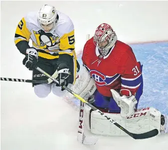  ?? FRANK GUNN, THE CANADIAN PRESS ?? Canadiens goaltender Carey Price makes a save as Penguins forward Teddy Blueger leaps out of the way during the first period of Game 3 in Toronto on Wednesday.