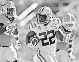  ?? JONATHAN BACHMAN/GETTY ?? LSU’s Clyde Edwards-Helaire carries the ball Saturday. He ran for 145 yards in the win.