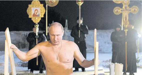  ?? Alexei Druzhinin ?? > Russian President Vladimir Putin bathes in ice-cold water on Epiphany neat St Nilus Stolobensk­y Monastery on Lake Seliger in Svetlitsa village, Russia. Thousands of Russian Orthodox Church members will plunge into icy rivers and ponds across the...