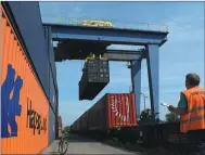  ?? WANG XIAO / FOR CHINA DAILY ?? Cargo is loaded onto trains at a railway station in Lodz, Poland. The city is one of the European destinatio­ns for the Chengdu rail express.